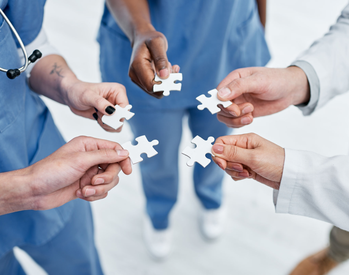 Medical professionals collaborating with puzzle pieces